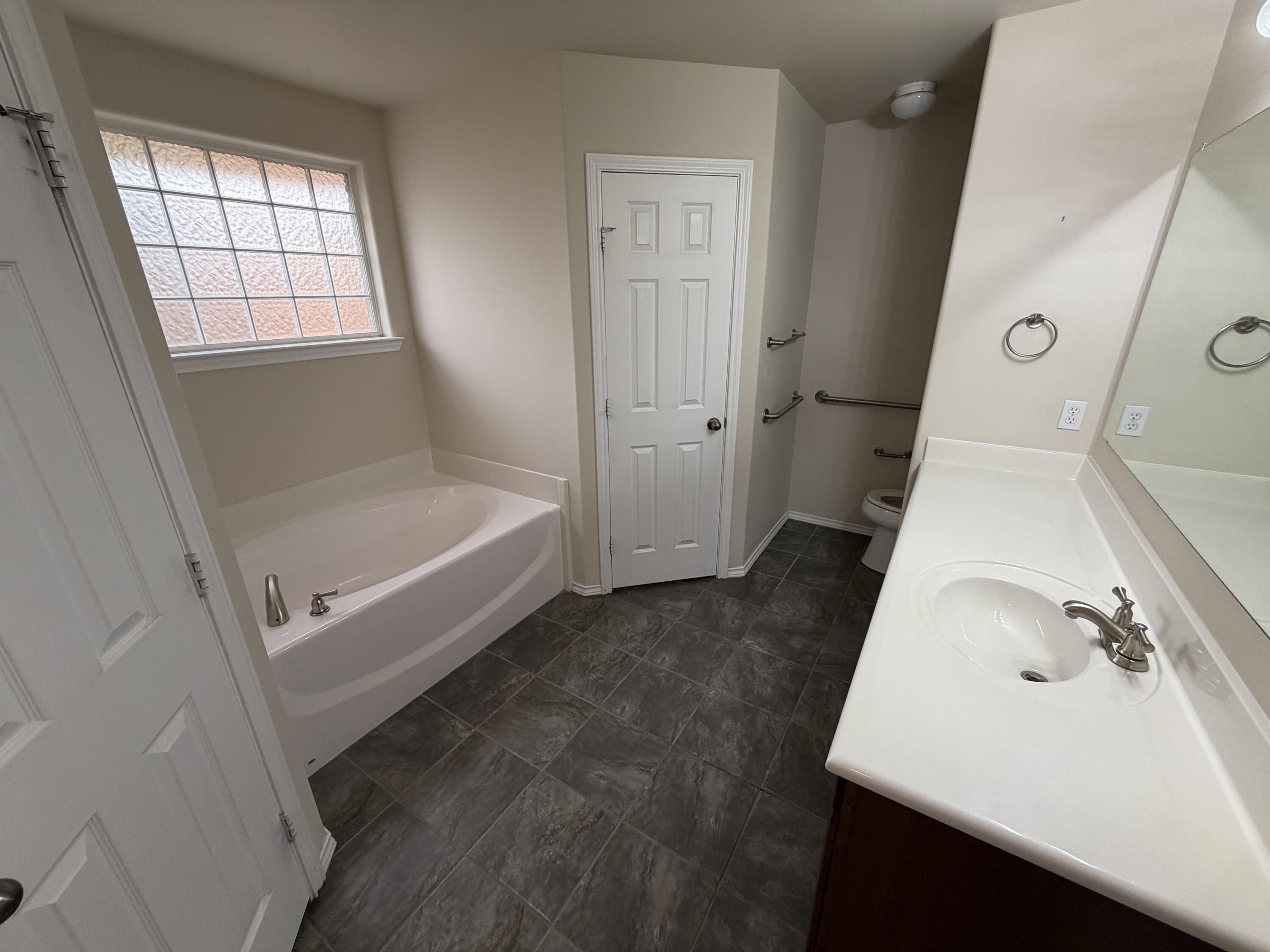 6544 84th Street Lubbock, TX 79424 - Photo 9 of 29 a bathroom with a sink and a bathtub