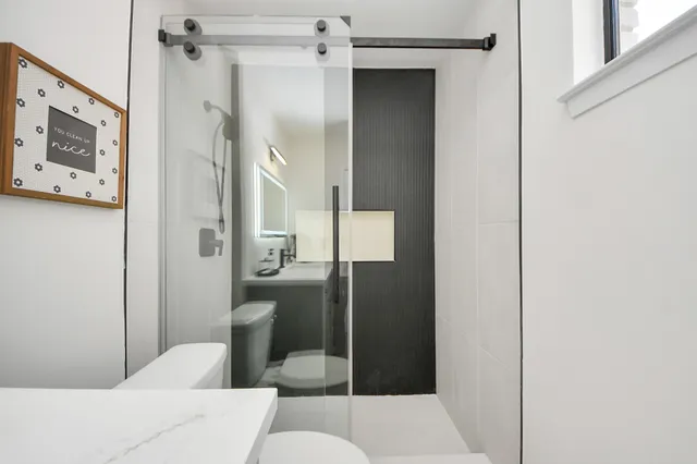 a bathroom with a toilet and a shower