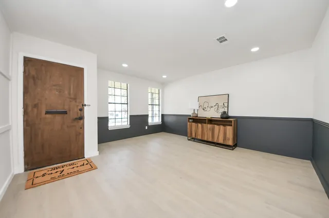 a view of an empty room with a cabinet
