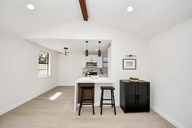 a view of a workspace with furniture and a window