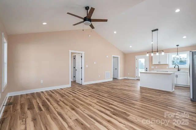 a kitchen with a sink a counter space appliances and cabinets