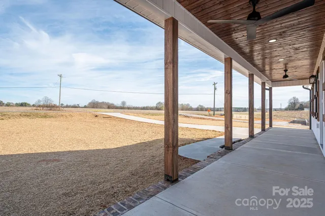 a view of a kitchen with a sink and wooden floor