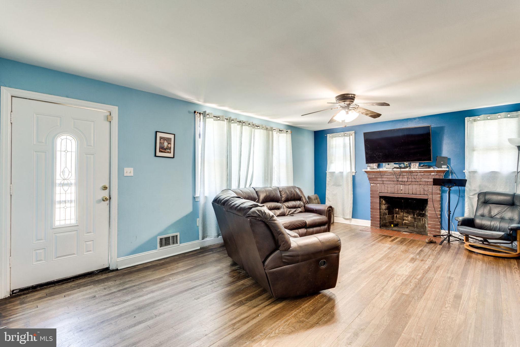 14001 Livingston Road Clinton, MD 20735 - Photo 7 of 28 a living room with furniture a fireplace and a flat screen tv