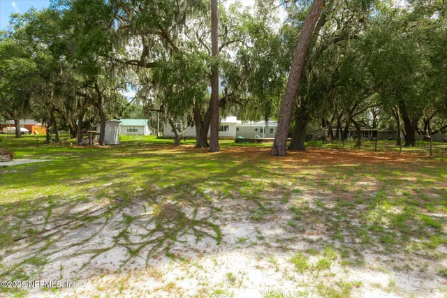 a view of a yard with a lake view