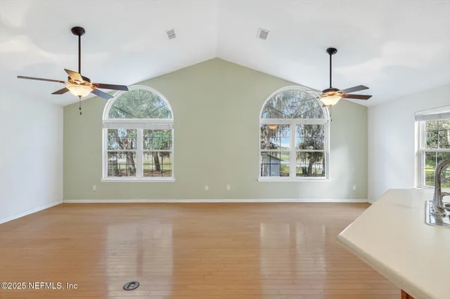 a view of a kitchen with a sink hardwood floor and a kitchen