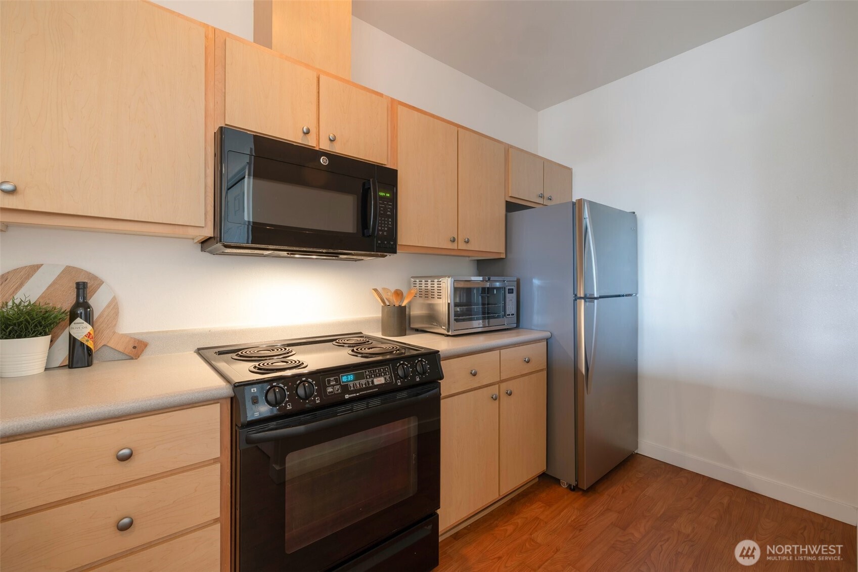 13301 Southeast 79th Place, Unit B402 Newcastle, WA 98059 - Photo 17 of 25 a kitchen with stainless steel appliances a stove microwave and refrigerator