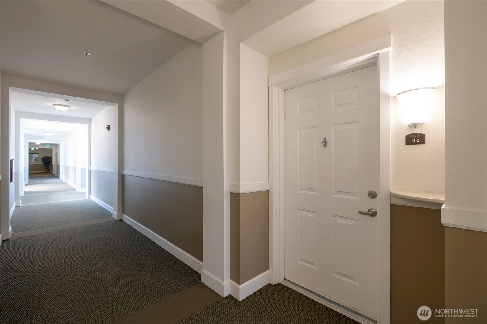 13301 Southeast 79th Place, Unit B402 Newcastle, WA 98059 - Photo 19 of 25 a view of a hallway with wooden shelves
