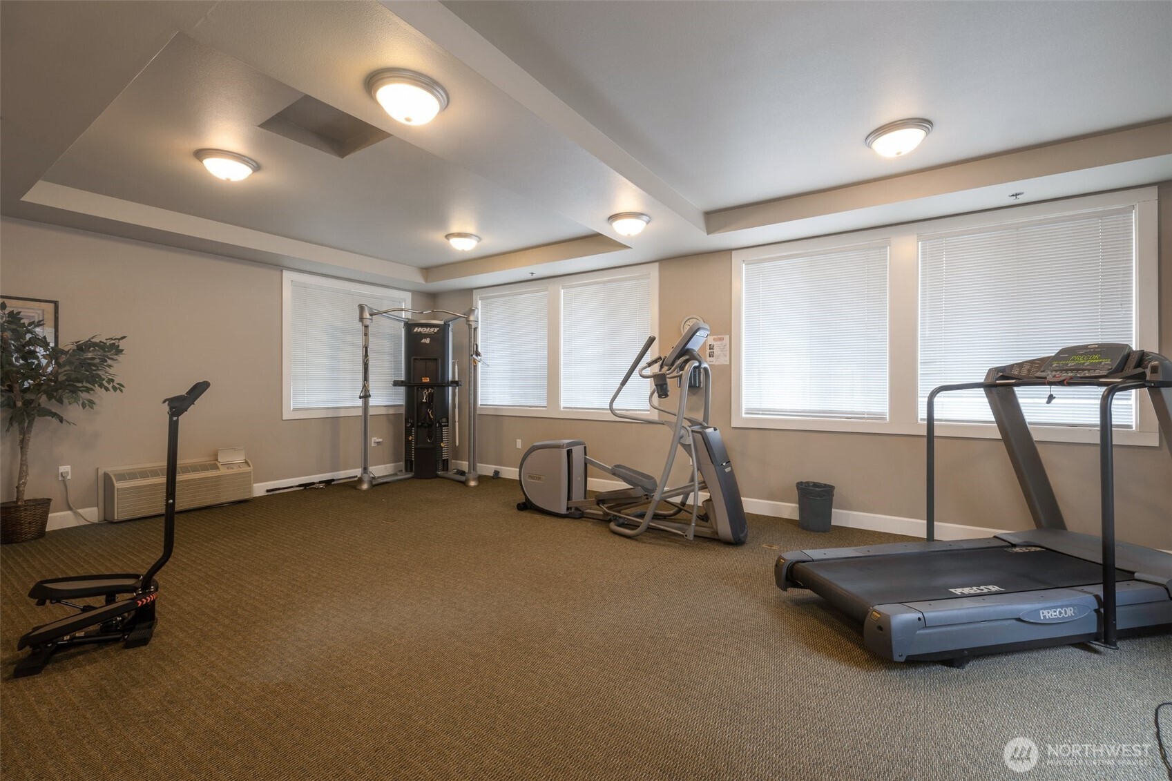 13301 Southeast 79th Place, Unit B402 Newcastle, WA 98059 - Photo 21 of 25 a room with gym equipment and a large window