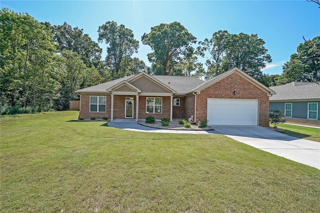 a front view of a house with yard porch and green space