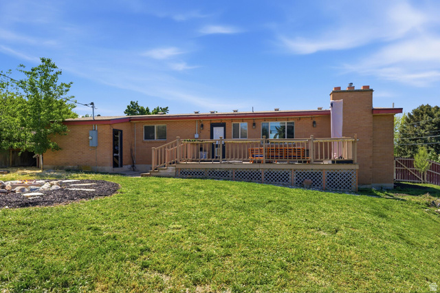 935 900 North Bountiful, UT 84010 - Photo 37 of 46 Back of property featuring a deck, brick siding, and a chimney