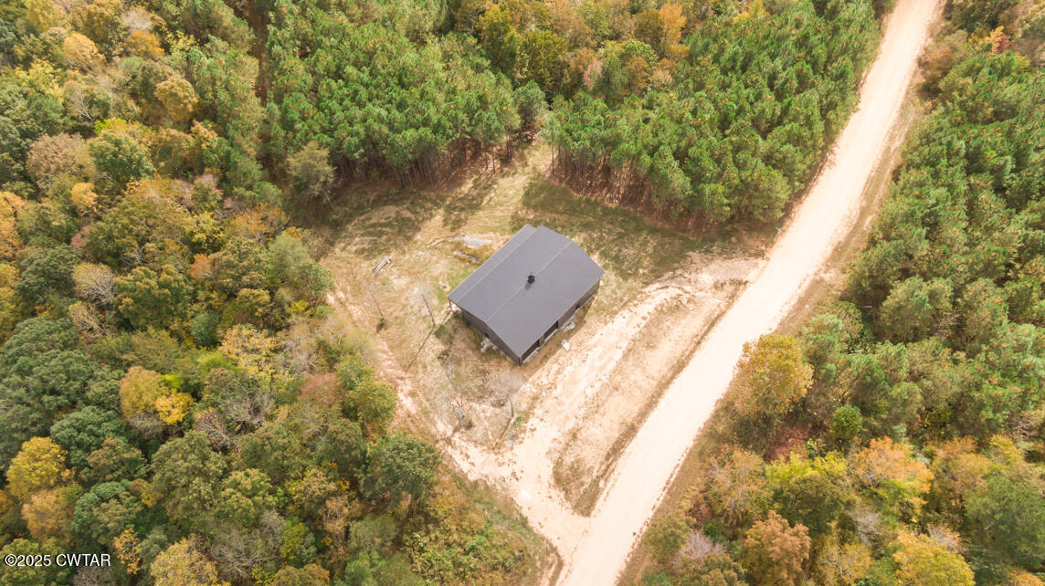 190 Pine Tree Drive Parsons, TN 38363 - Photo 3 of 56 a view of a yard with plants and wooden fence