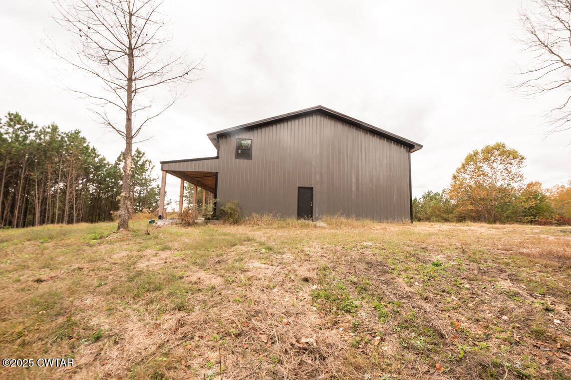 190 Pine Tree Drive Parsons, TN 38363 - Photo 34 of 56 a backyard of a house with large trees