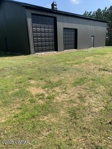 190 Pine Tree Drive Parsons, TN 38363 - Photo 5 of 56 a view of an house with backyard space and garage