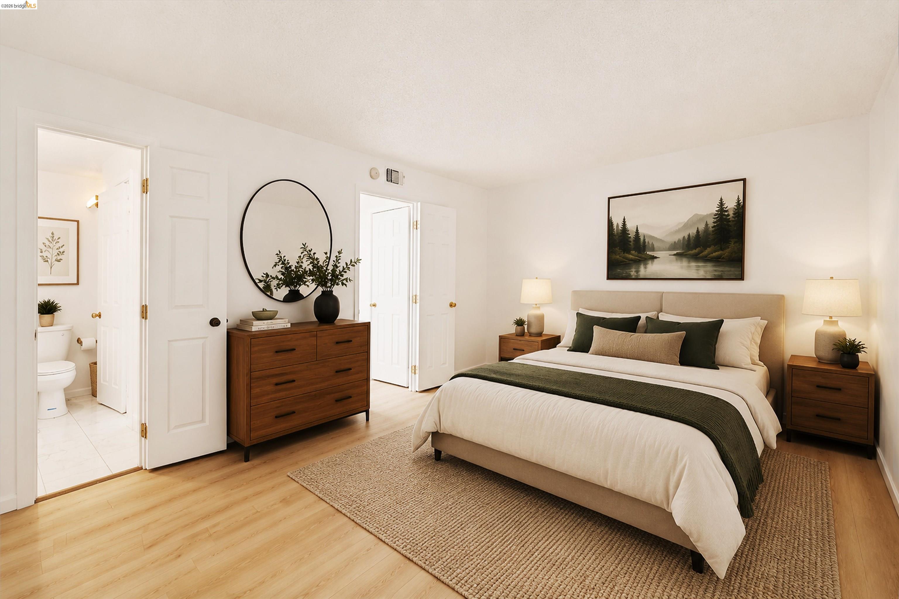 4186 San Pablo Dam Road, Unit A El Sobrante, CA 94803 - Photo 10 of 34 Well-lit bedroom with light wood-finish flooring, white walls, and two white paneled doors