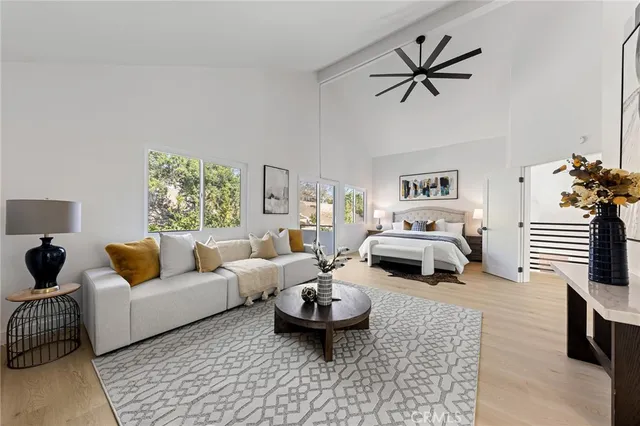 a living room with furniture a rug and a table