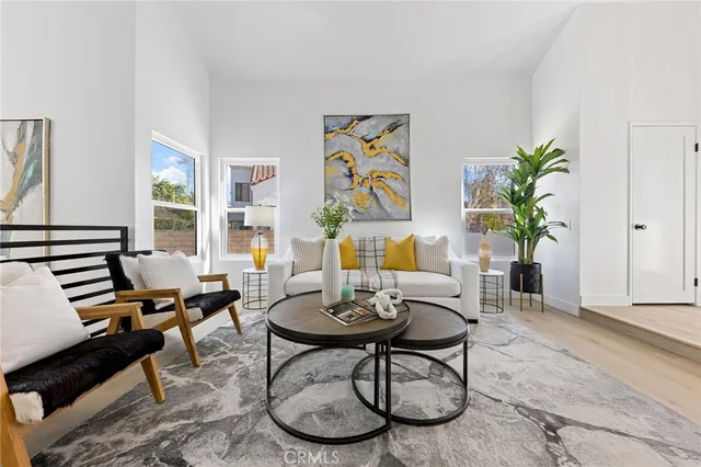 a living room with furniture a chandelier and a window