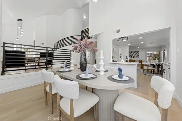 a dining room with furniture and wooden floor