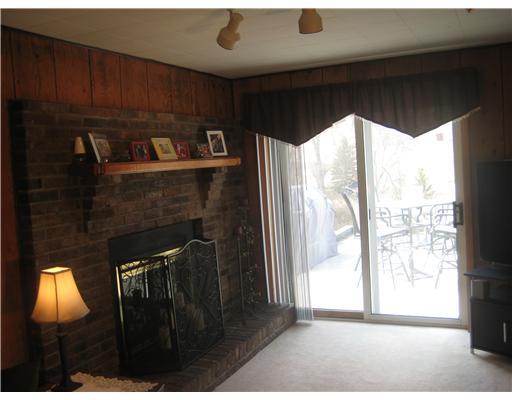 416 Nike Road Coraopolis, PA 15108 - Photo 13 of 18 Family Room. View of the log burning fireplace in the family room with brick surround and mantle and the sliding door to the stone paver patio.
