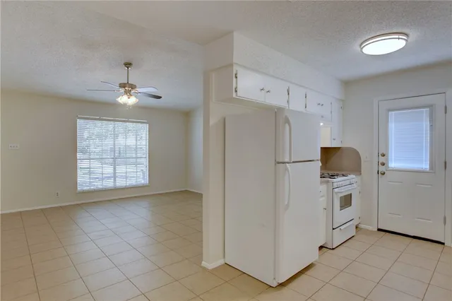 a kitchen with stainless steel appliances granite countertop white cabinets sink and dishwasher