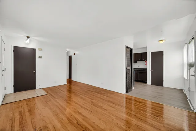 a view of an empty room with closet and a window