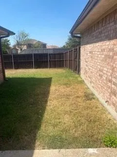 a view of a house with a yard and sitting area