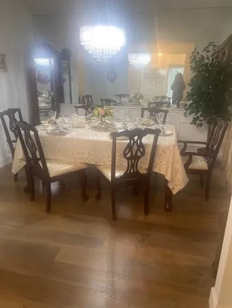 a dining room with furniture and a mirror