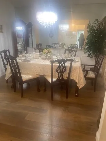 a dining room with furniture and a mirror