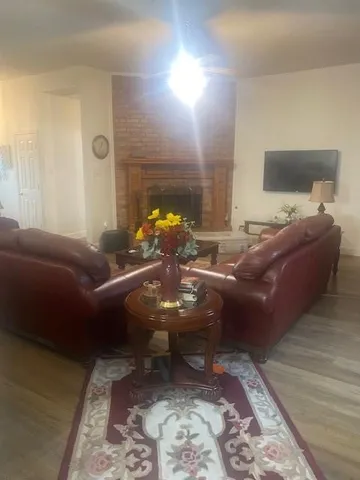 a living room with furniture and a lamp