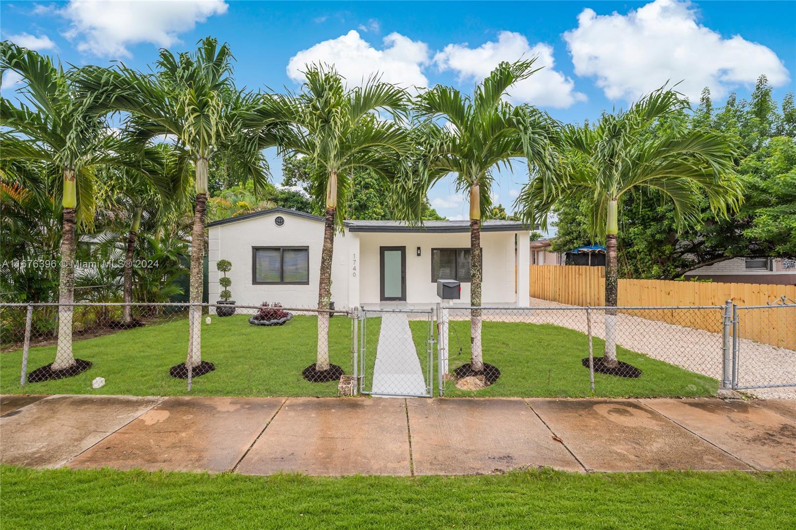 1740 Northwest 53rd Street Miami, FL 33142 - Photo 1 of 25 a view of a house with backyard and a tree