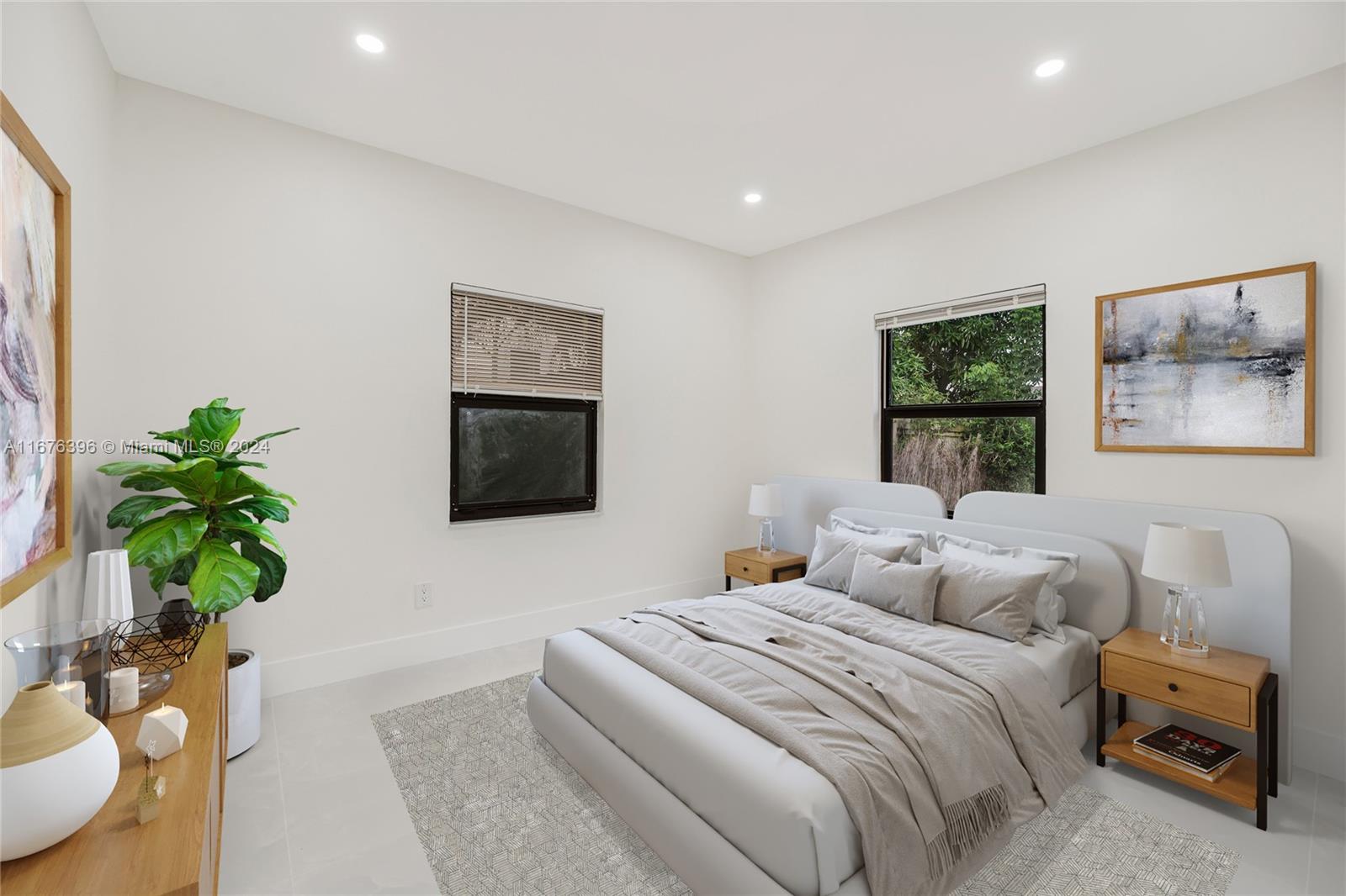 1740 Northwest 53rd Street Miami, FL 33142 - Photo 12 of 25 a bedroom with a bed and a potted plant