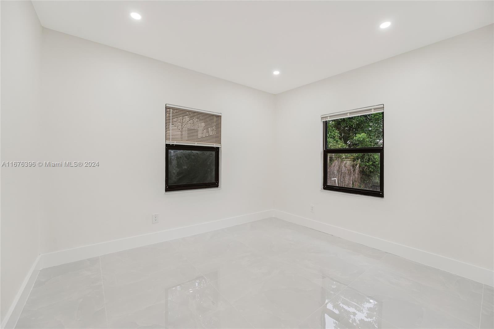 1740 Northwest 53rd Street Miami, FL 33142 - Photo 13 of 25 an empty room with windows