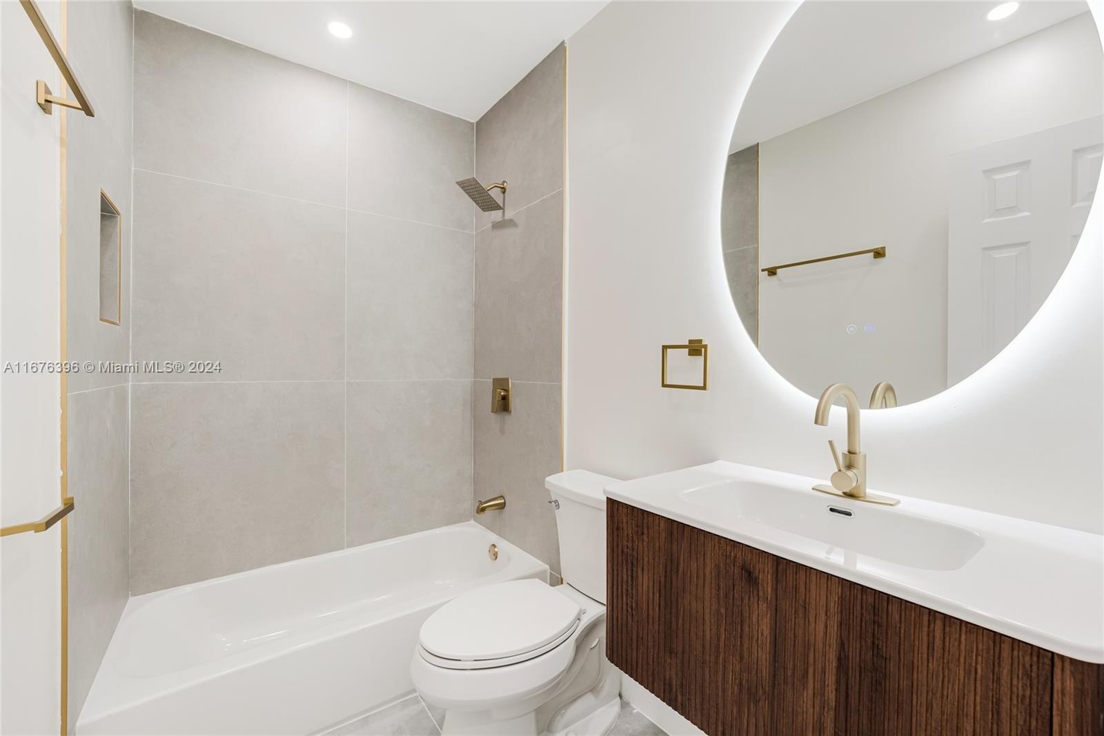 1740 Northwest 53rd Street Miami, FL 33142 - Photo 14 of 25 a bathroom with a sink a toilet and a mirror