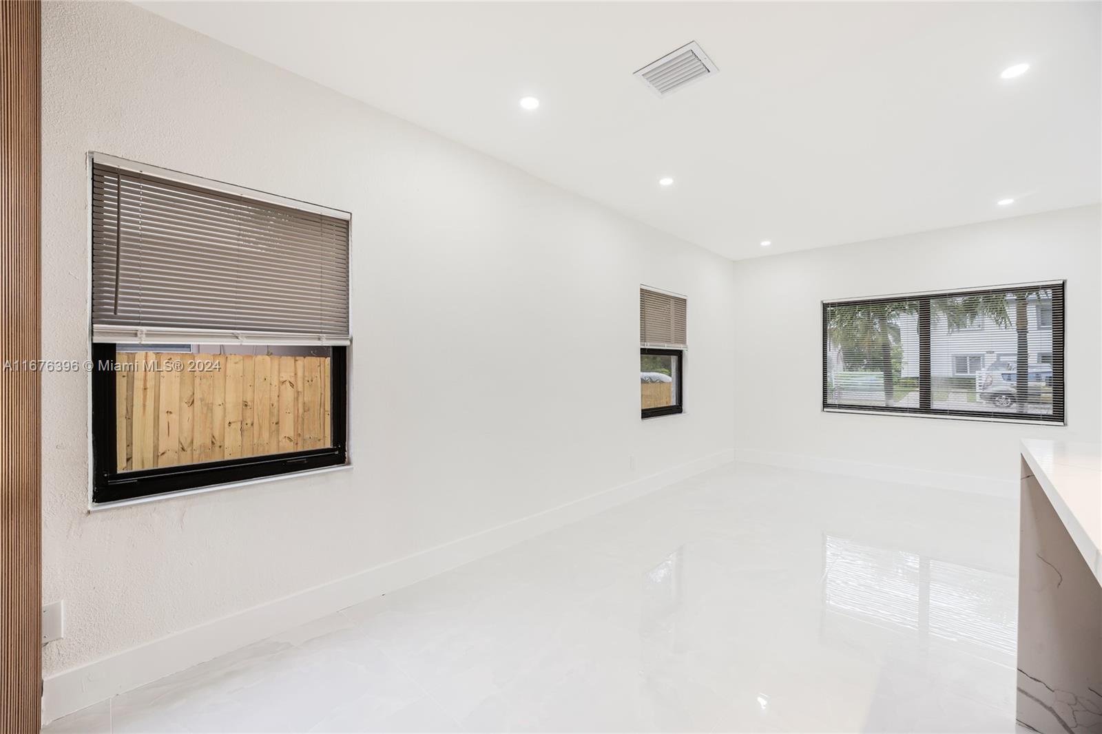 1740 Northwest 53rd Street Miami, FL 33142 - Photo 19 of 25 a view of an empty room with windows and cabinet
