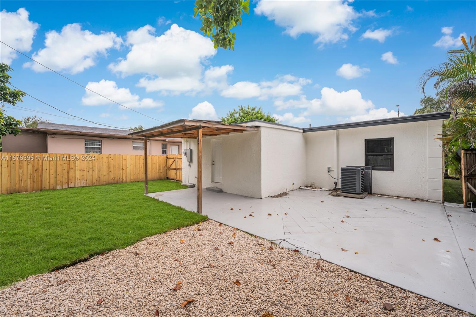 1740 Northwest 53rd Street Miami, FL 33142 - Photo 23 of 25 a view of a house with a backyard