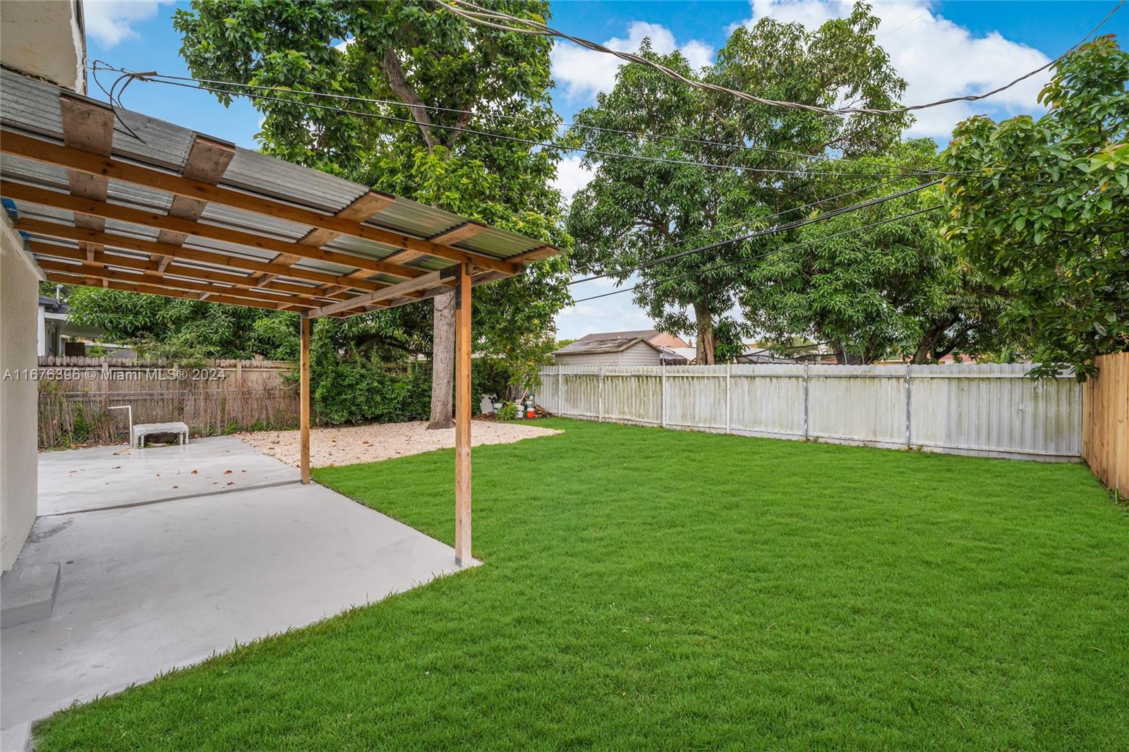 1740 Northwest 53rd Street Miami, FL 33142 - Photo 25 of 25 a view of a backyard with a small cabin and a chair