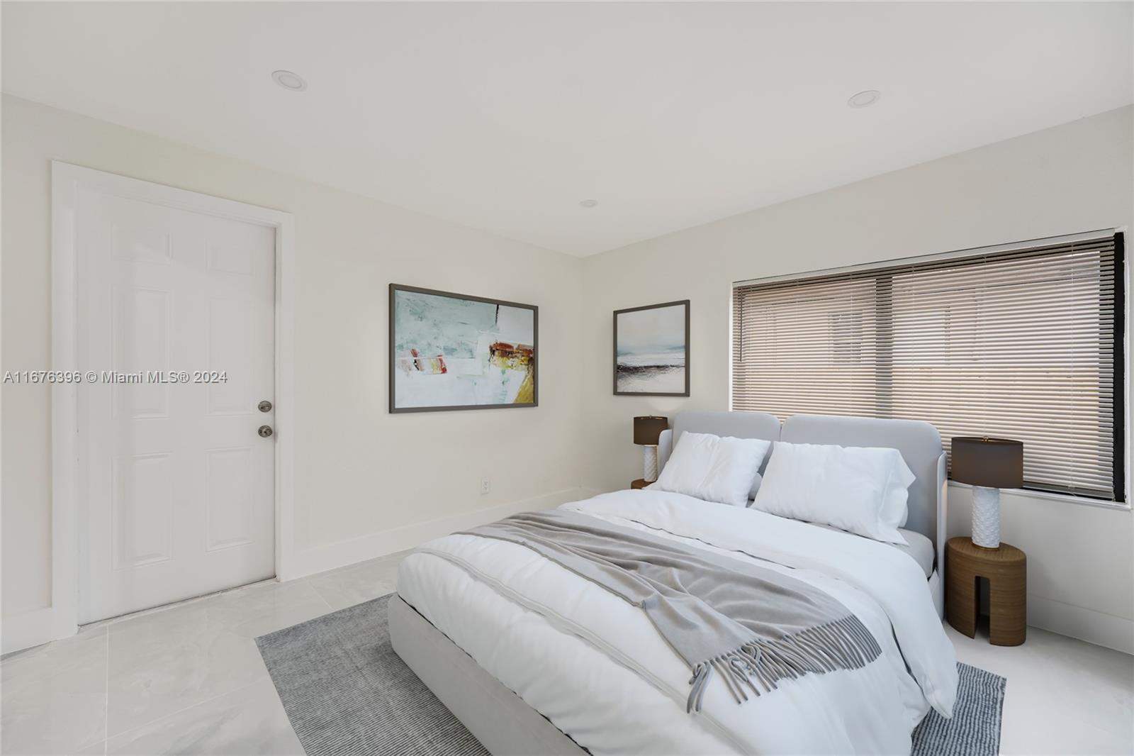 1740 Northwest 53rd Street Miami, FL 33142 - Photo 8 of 25 a bedroom with a bed and a painting on the wall