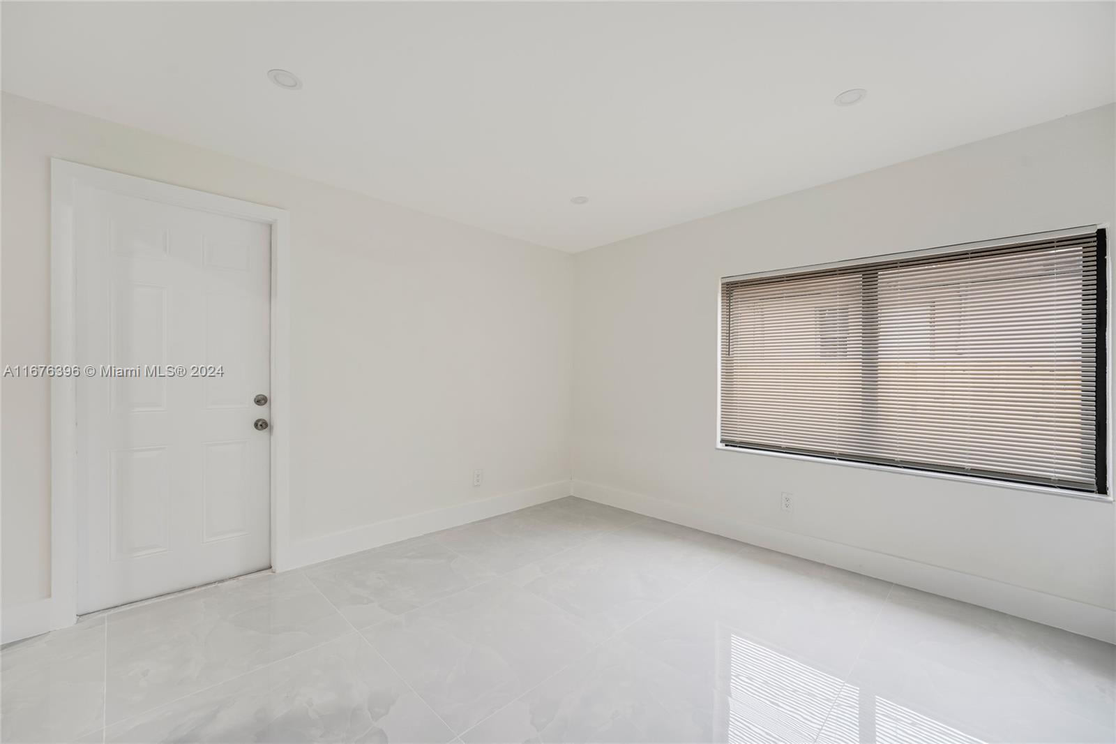 1740 Northwest 53rd Street Miami, FL 33142 - Photo 9 of 25 a view of an empty room with a window