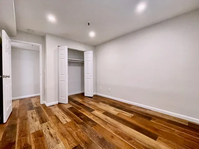 a view of a room with wooden floor