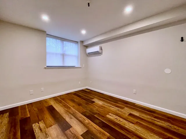 a view of a room with wooden floor
