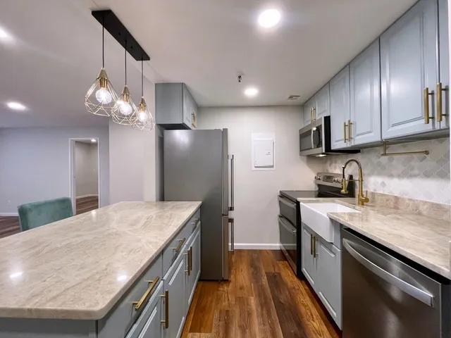 a kitchen with a sink stove and refrigerator