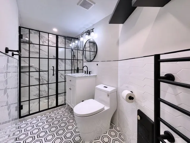 a bathroom with a toilet and a shower