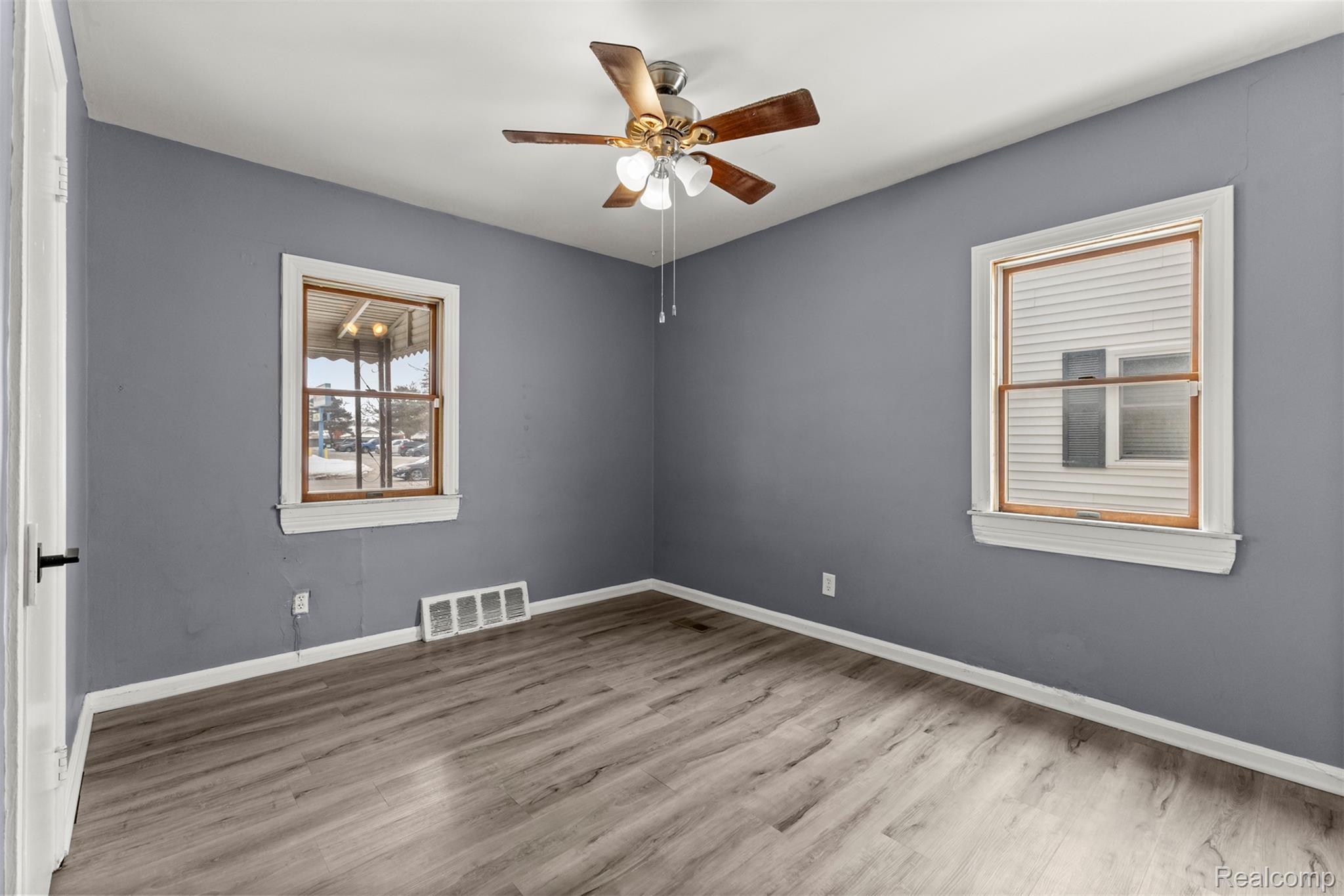 14716 Eureka Road Southgate, MI 48195 - Photo 18 of 42 Unfurnished room with a ceiling fan and wood finished floors