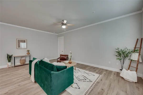a living room with furniture and wooden floor