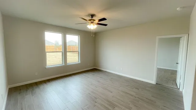 a kitchen with granite countertop a sink dishwasher stove and cabinets