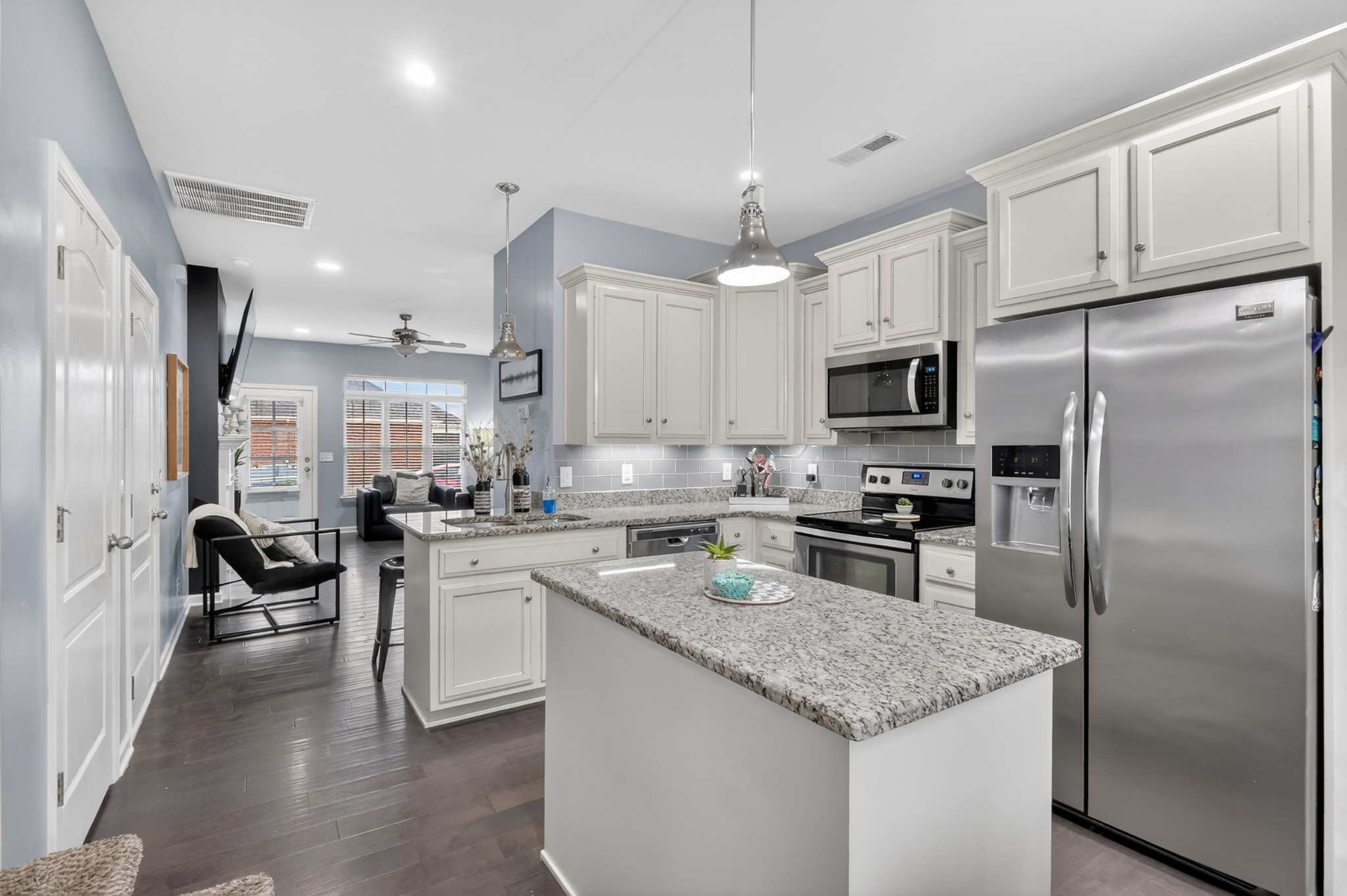 706 Indian Ridge Circle White House, TN 37188 - Photo 14 of 42 a kitchen with stainless steel appliances granite countertop a refrigerator a stove a sink a dining table and chairs with wooden floor