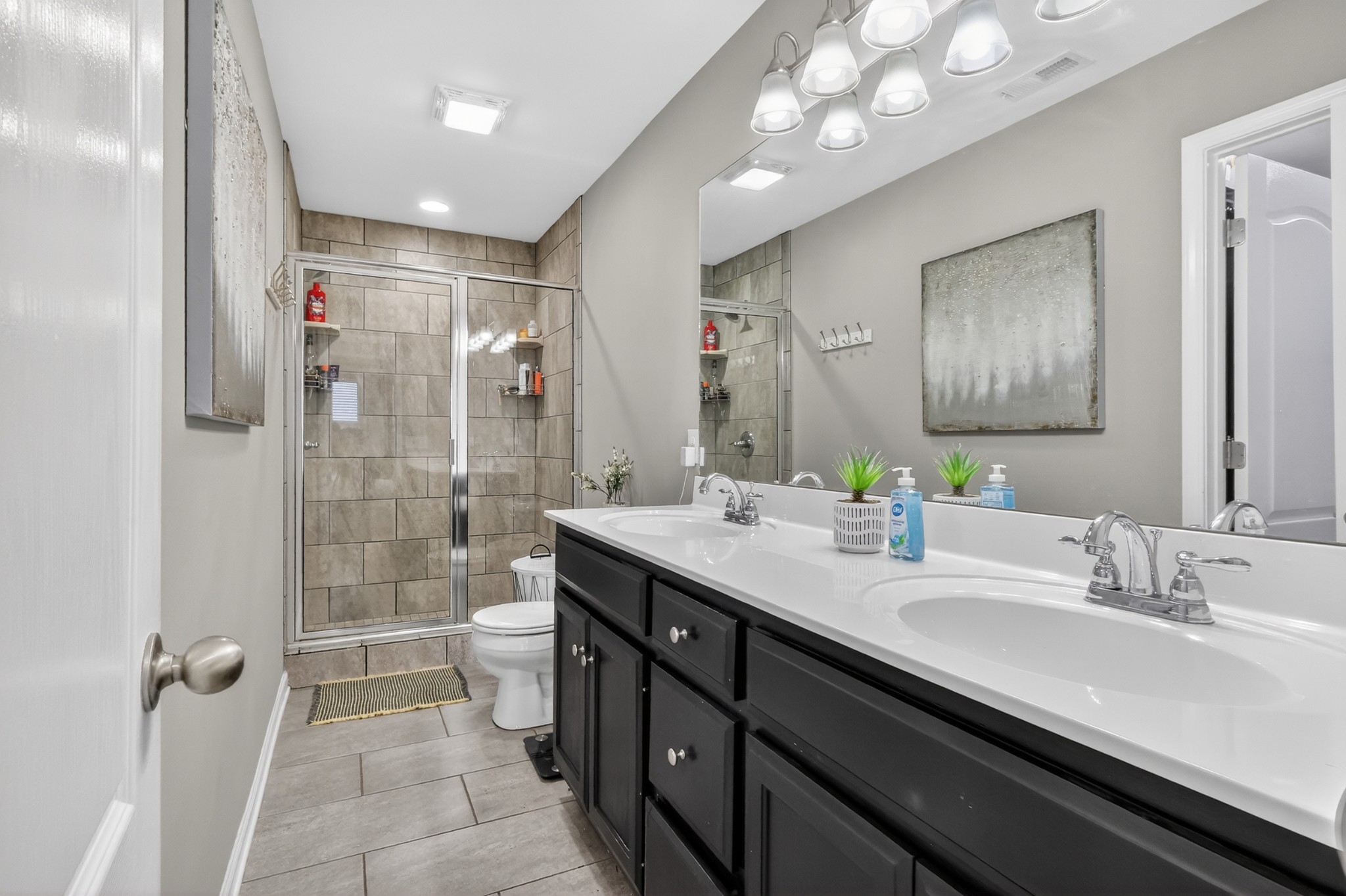 706 Indian Ridge Circle White House, TN 37188 - Photo 24 of 42 a bathroom with a double vanity sink mirror and shower