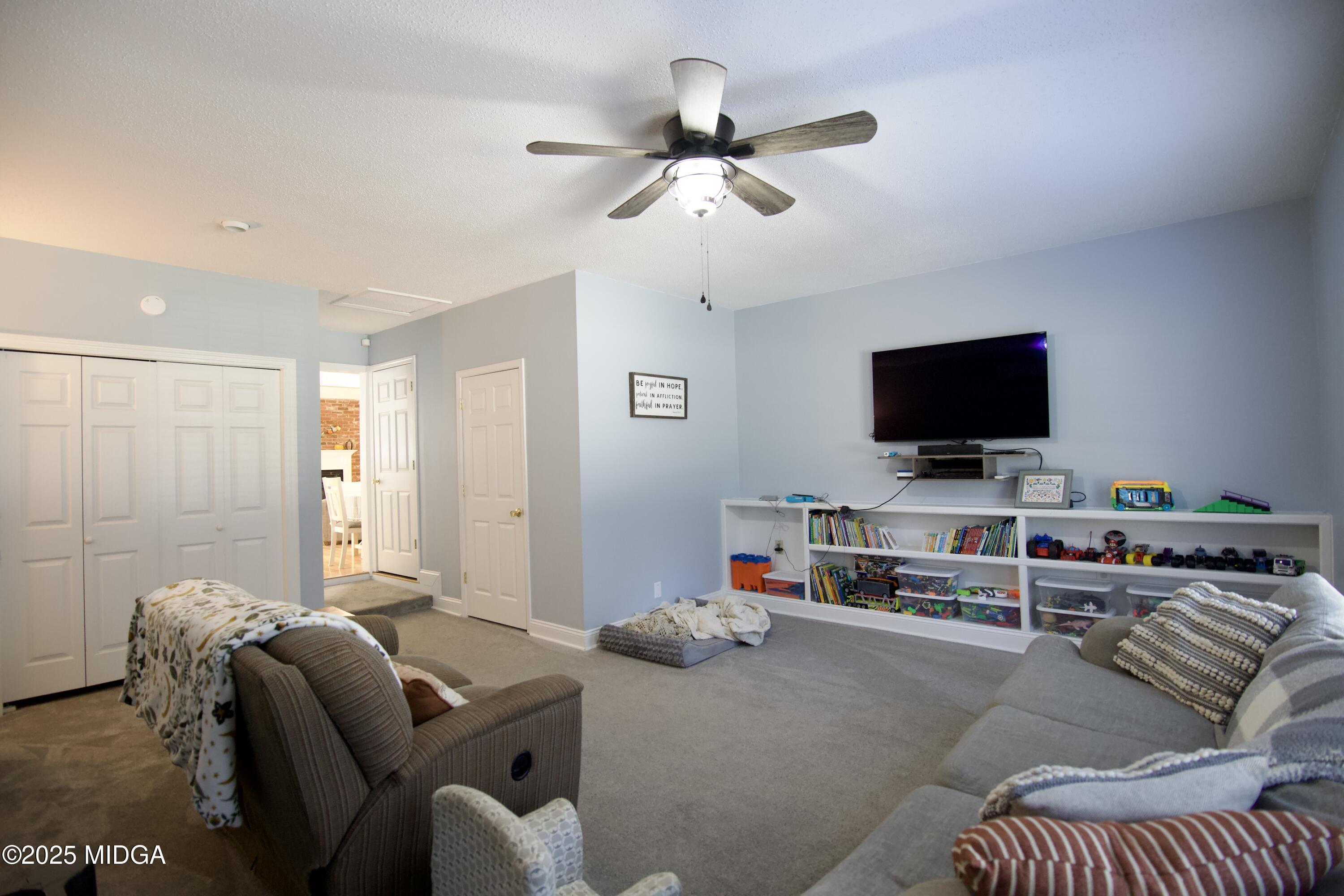 1205 Morningside Drive Perry, GA 31069 - Photo 11 of 31 a living room with furniture and a flat screen tv