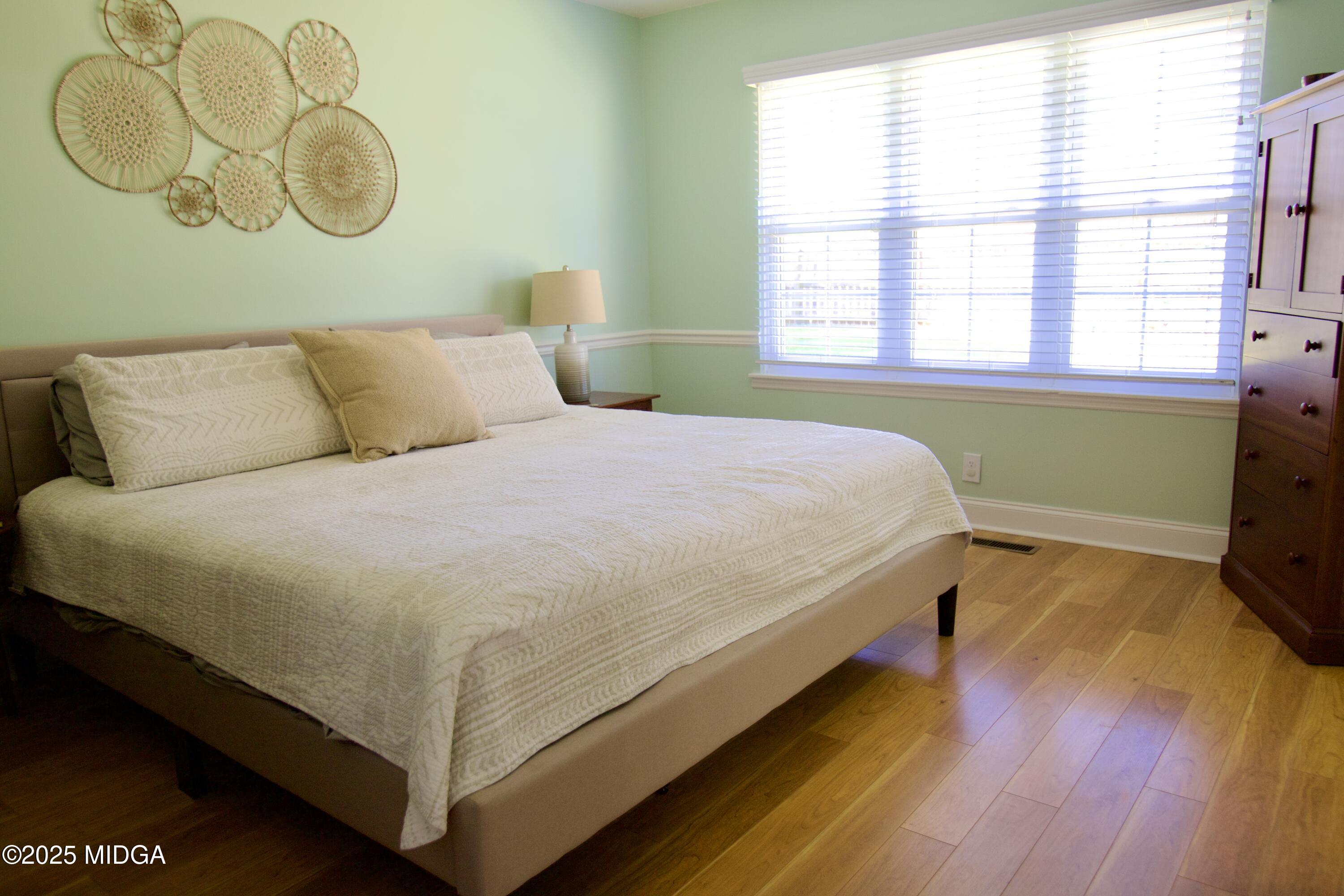 1205 Morningside Drive Perry, GA 31069 - Photo 13 of 31 a bed sitting in a bedroom next to a window