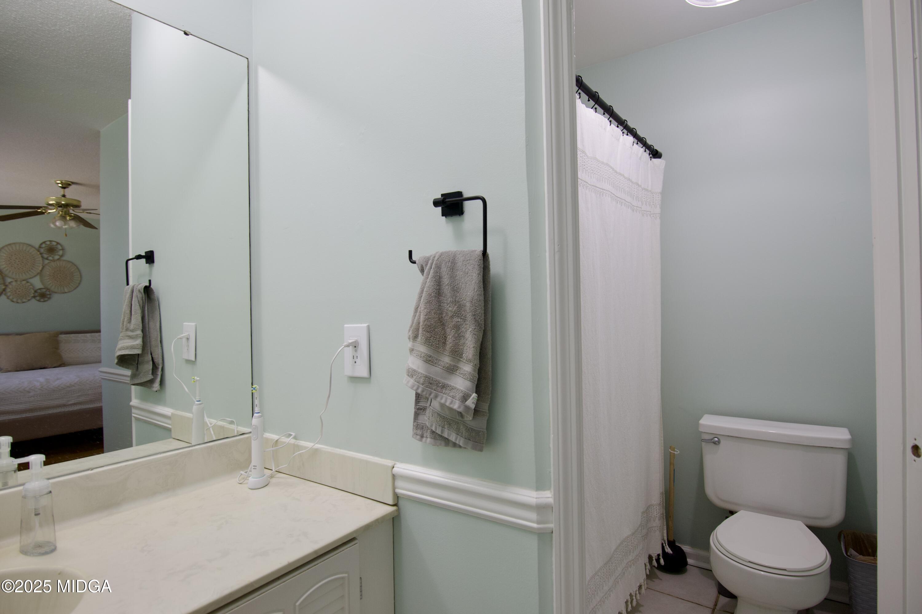 1205 Morningside Drive Perry, GA 31069 - Photo 16 of 31 a bathroom with a sink a toilet and shower