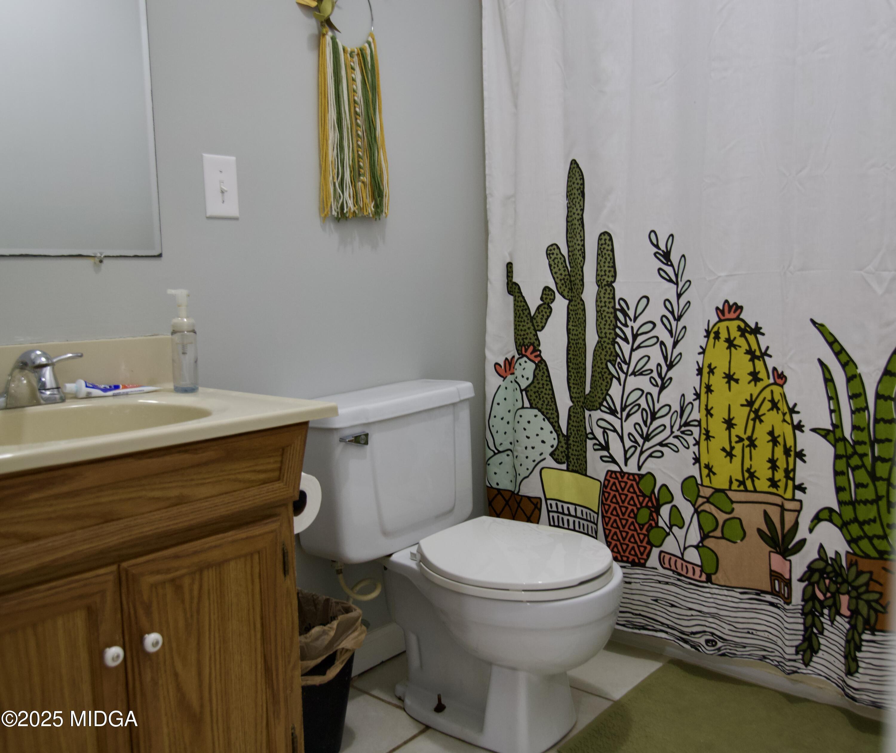 1205 Morningside Drive Perry, GA 31069 - Photo 17 of 31 a bathroom with a toilet sink and mirror